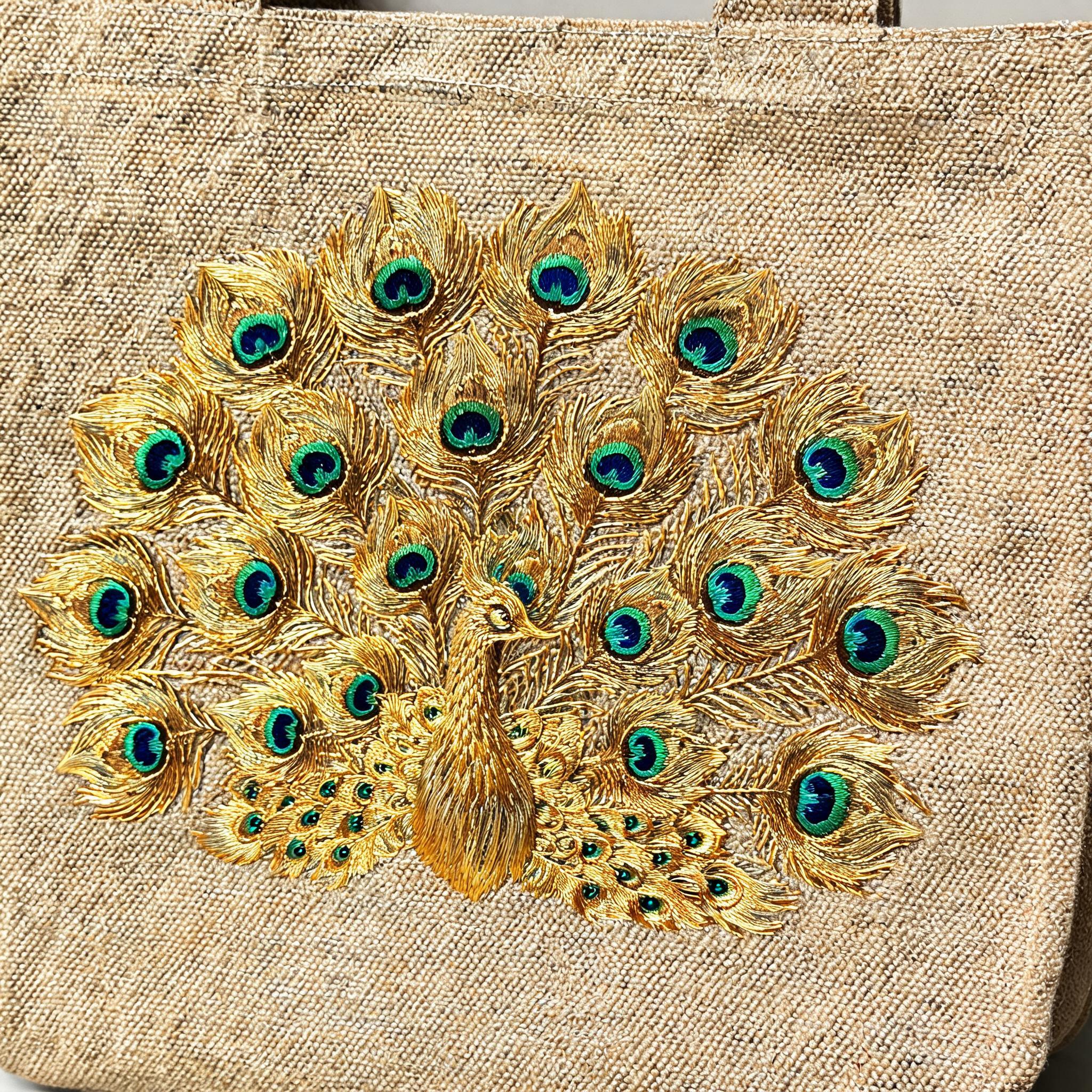 Close-up detail of peacock embroidery on canvas bag showing golden silk thread feather pattern in traditional Chinese needlework style.